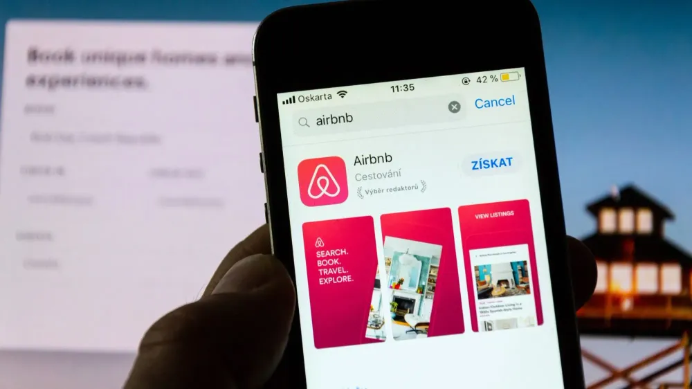 Airbnb logo and app on phone.